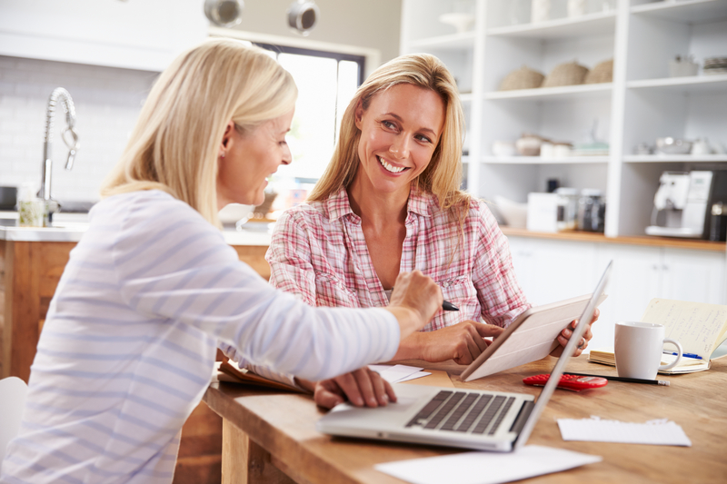 Two women working together on an IPad